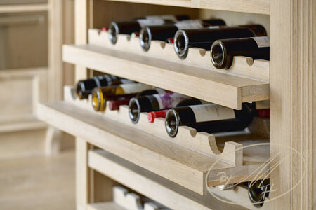 Material: oak veneer, solid oak, oil. Detail of the wine cellar.